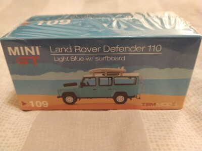 MINI GT 109 Land Rover Defender 110 Light Blue w/ Surfboard RHD