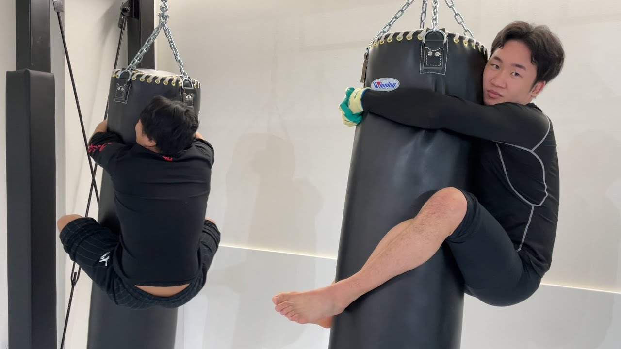 Endurance challenge by hanging from a punching bag, phone call to