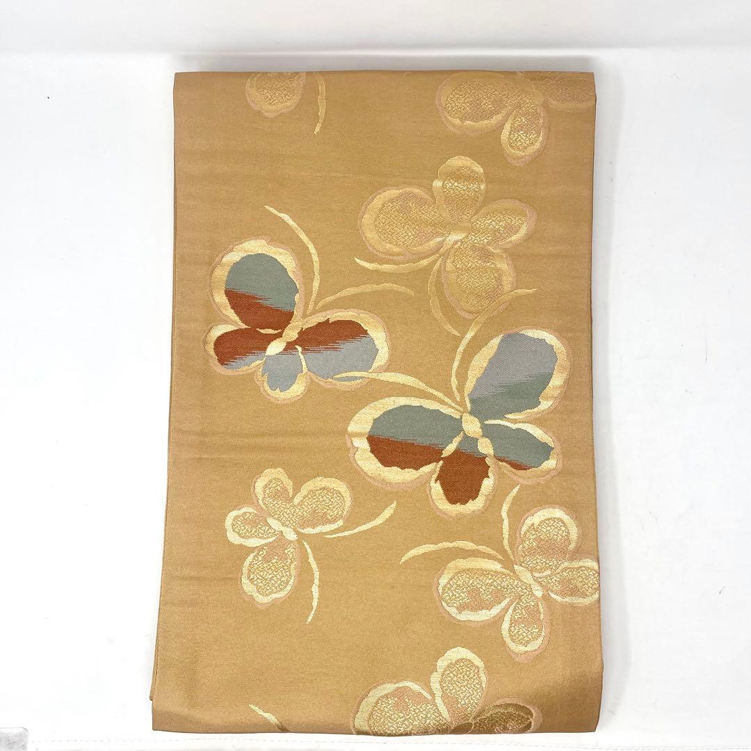 名古屋帯/ポリエステル ］化繊 柔らかい橙系の色 蝶 洗濯 洗える