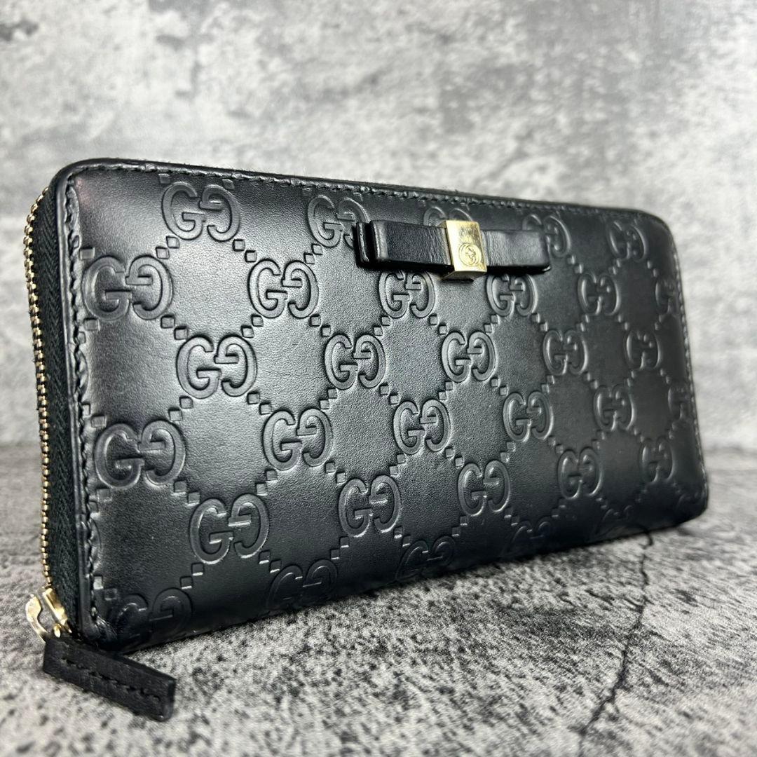 GUCCI GGエンボス インターロッキング リボン金具 ラウンド 長財布
