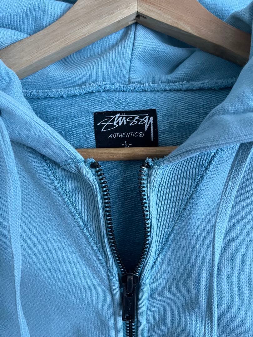 STUSSY ライトブルー ジップアップパーカー Lサイズ - メルカリ