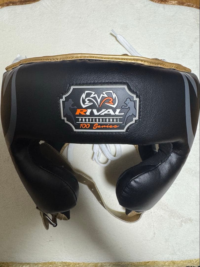 RIVAL 100シリーズ ヘッドギア M ゴールド/ブラック