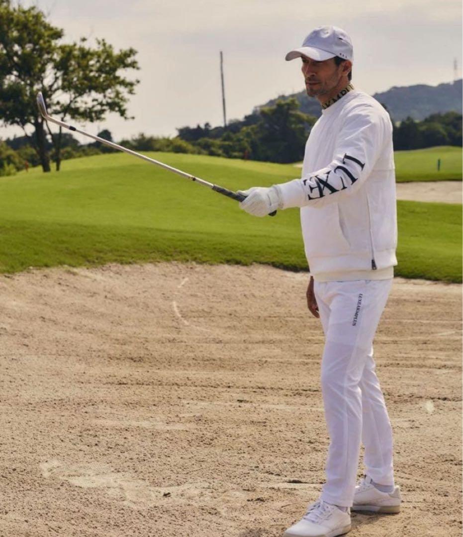 リュクスエイケイエムプラス ゴルフ 防風 サークルロゴウィンドウパンツ＆ウェア