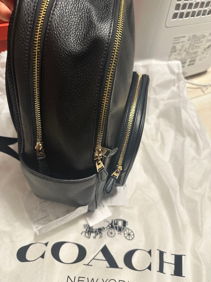 バッグ COACH PEBBLED LEATHER COURT BACKPACK