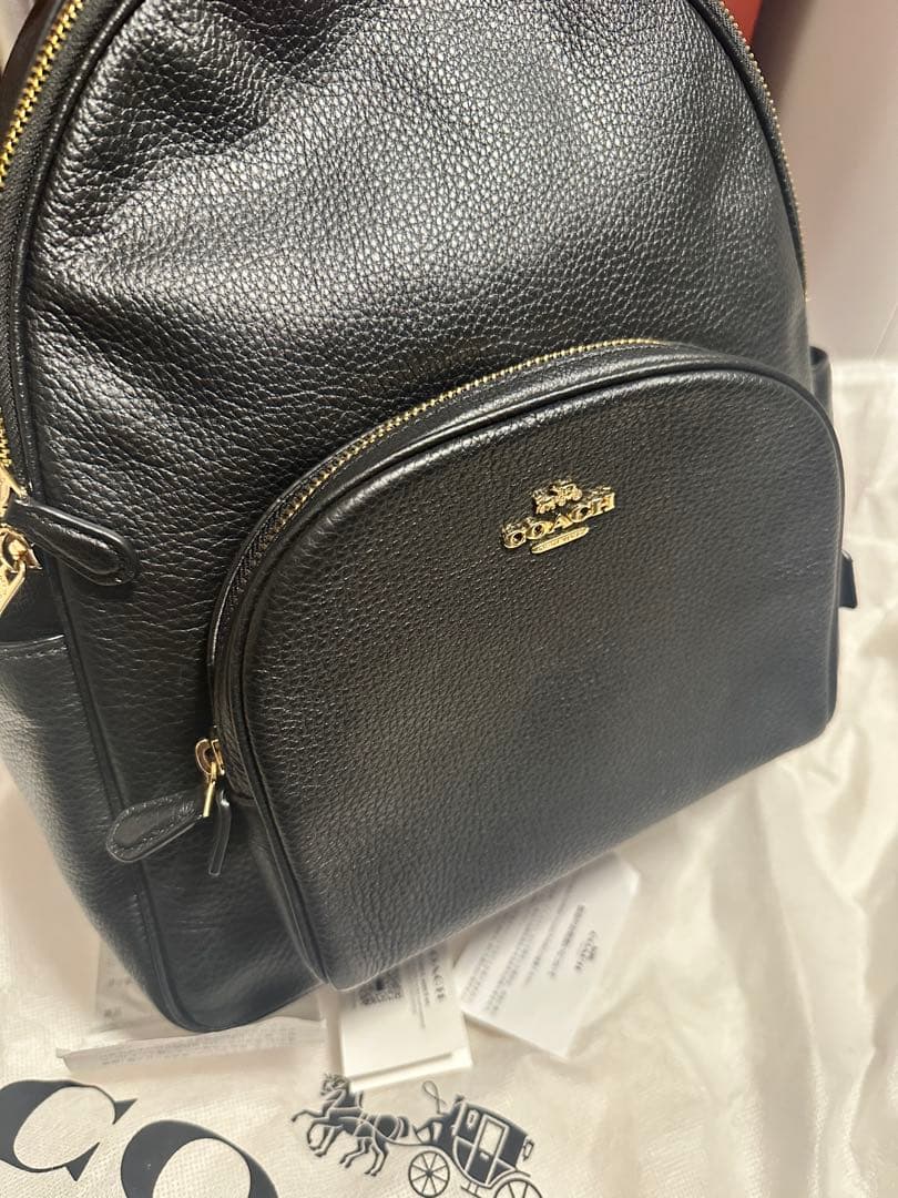 バッグ COACH PEBBLED LEATHER COURT BACKPACK